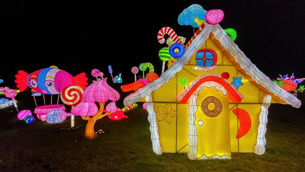 the candyland section of the thursford enchanted journey of light featuring a life-sized gingerbread house
