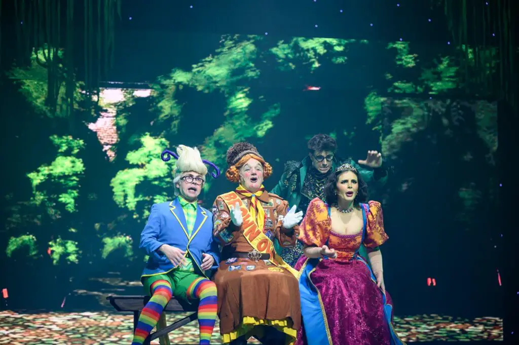 The Fairy, the Queen, and The Princess on a bench on stage at Norwich Theatre Royal