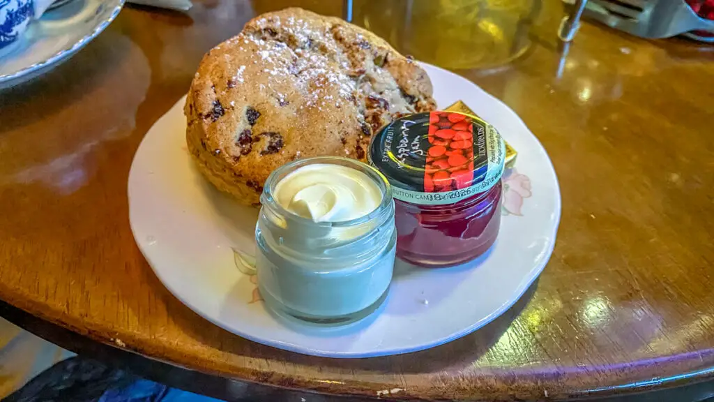 close up of the spiced scone from Biddy's with clotted cream and jam on a plate