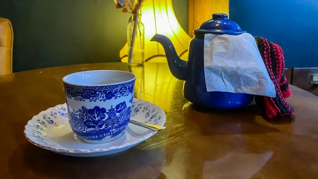 tea pot with tea cup and saucer on a table at biddys team room